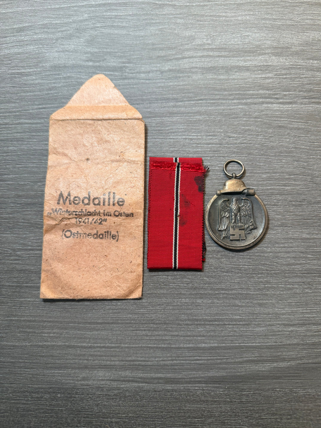 Original WWII German Eastern Front Medal (Ostmedaille) w/ Packet &amp; Ribbon – Maker Marked “77” – Complete Set