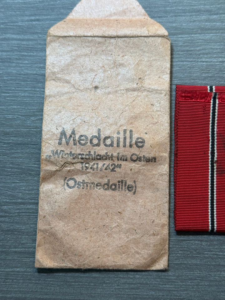 Original WWII German Eastern Front Medal (Ostmedaille) w/ Packet &amp; Ribbon – Maker Marked “77” – Complete Set