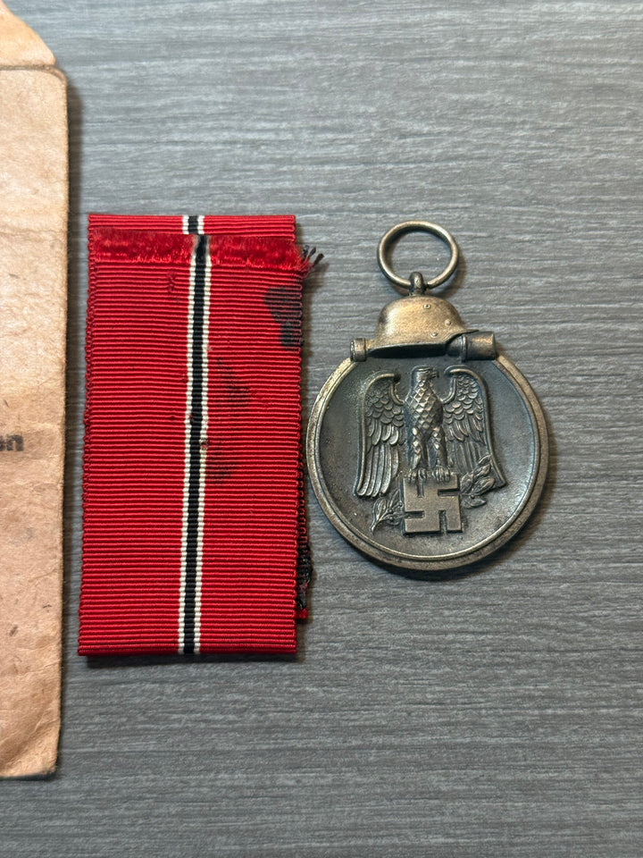 Original WWII German Eastern Front Medal (Ostmedaille) w/ Packet &amp; Ribbon – Maker Marked “77” – Complete Set