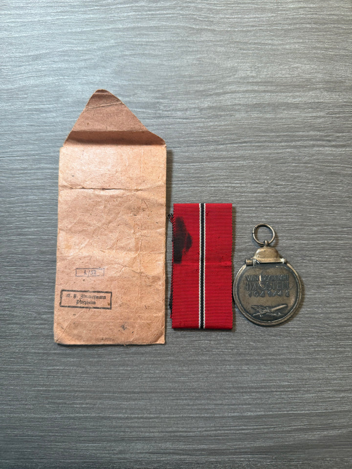 Original WWII German Eastern Front Medal (Ostmedaille) w/ Packet &amp; Ribbon – Maker Marked “77” – Complete Set