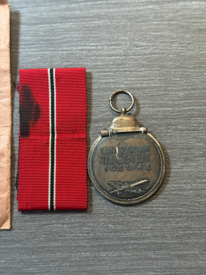 Original WWII German Eastern Front Medal (Ostmedaille) w/ Packet &amp; Ribbon – Maker Marked “77” – Complete Set