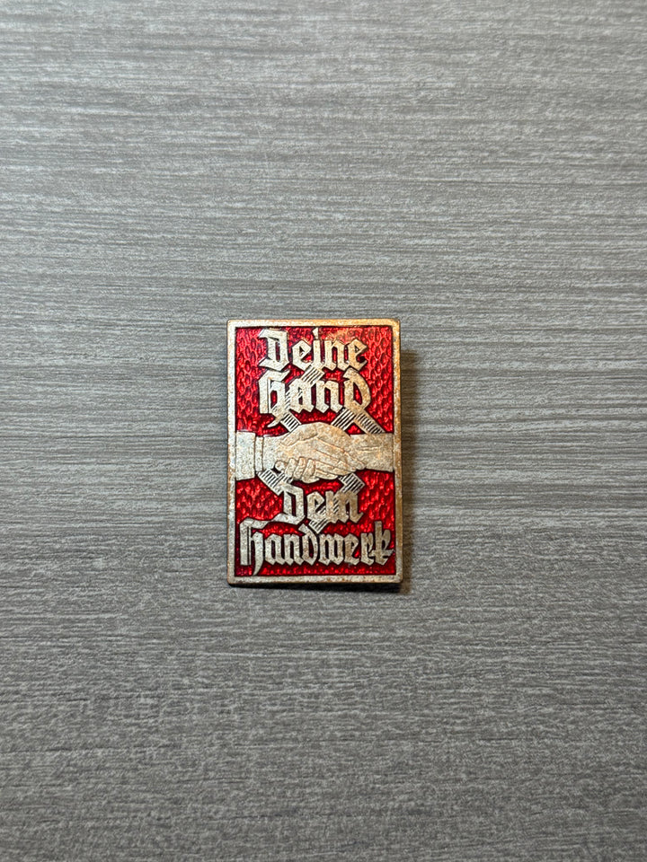 Original WWII German “Deine Hand Der Handwerk” Badge – Red Enamel –
